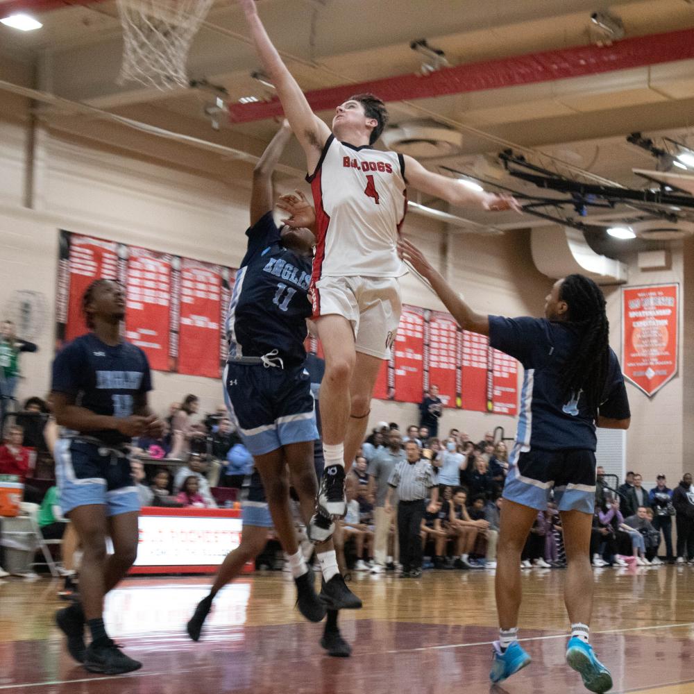 High-flying Old Rochester player Liam Geraghty helped bring the Bulldogs into the MIAA final four during a game against Boston’s English High School in March. Photo by Sawyer Smook-Pollitt